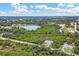 Aerial view of a house by a lake, highlighting its serene location and neighborhood at 6153 Pennell St, Englewood, FL 34224