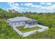 Single-story home with metal roof, screened patio, and fenced backyard at 6153 Pennell St, Englewood, FL 34224