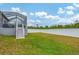 Large backyard with grassy area and privacy fence at 6153 Pennell St, Englewood, FL 34224