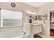 Bright bathroom with a bathtub and double vanity at 6153 Pennell St, Englewood, FL 34224