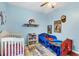 ' bedroom with a crib and Spiderman-themed bed at 6153 Pennell St, Englewood, FL 34224