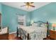 Bedroom with a ceiling fan, queen bed, and wood floors at 6153 Pennell St, Englewood, FL 34224