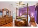 Spacious bedroom with a canopy bed and plenty of natural light at 6153 Pennell St, Englewood, FL 34224