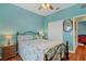 Bedroom with ceiling fan, queen bed, and mirrored closet doors at 6153 Pennell St, Englewood, FL 34224