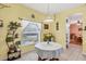 Separate dining area with a round table and a view into the kitchen area at 6153 Pennell St, Englewood, FL 34224