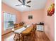 Dining area with wooden table and chairs, hardwood floors, and peach walls at 6153 Pennell St, Englewood, FL 34224