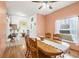 Dining area with wooden table and chairs, hardwood floors, and peach walls at 6153 Pennell St, Englewood, FL 34224