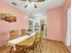 Dining area with wooden table and chairs, hardwood floors, and peach walls at 6153 Pennell St, Englewood, FL 34224