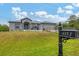 House exterior showcasing a gray metal roof and a blue front door at 6153 Pennell St, Englewood, FL 34224