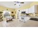 Galley kitchen with white cabinetry, stainless steel appliances, and a breakfast bar at 6153 Pennell St, Englewood, FL 34224