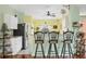 Bright kitchen with white cabinets, stainless steel appliances, and breakfast nook at 6153 Pennell St, Englewood, FL 34224