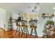 Kitchen features a breakfast bar with three stools and hardwood floors at 6153 Pennell St, Englewood, FL 34224