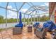 Relaxing screened patio with seating area and fire pit at 6153 Pennell St, Englewood, FL 34224