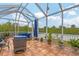 Relaxing screened patio with seating area and lush landscaping at 6153 Pennell St, Englewood, FL 34224