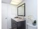 Bathroom with dark vanity, granite countertop, and a large mirror at 66 Boundary Blvd # 280, Rotonda West, FL 33947