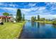 Scenic canal view with mature trees and landscaping at 66 Boundary Blvd # 280, Rotonda West, FL 33947