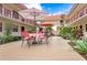 Inviting courtyard with seating area and lush landscaping at 66 Boundary Blvd # 280, Rotonda West, FL 33947
