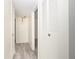 Bright hallway with linen closet and modern light fixture at 66 Boundary Blvd # 280, Rotonda West, FL 33947