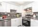 Modern kitchen featuring stainless steel appliances and white cabinetry at 66 Boundary Blvd # 280, Rotonda West, FL 33947