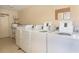 Shared laundry room with multiple washers and dryers at 66 Boundary Blvd # 280, Rotonda West, FL 33947