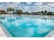 Large refreshing pool with surrounding lounge chairs at 66 Boundary Blvd # 280, Rotonda West, FL 33947