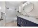 Updated bathroom with navy vanity, marble countertop, and subway tile at 660 Linden Dr, Englewood, FL 34223