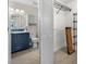 Bathroom with navy vanity and walk-in closet at 660 Linden Dr, Englewood, FL 34223