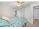 Bedroom with light walls, ceiling fan, and light blue bedding at 660 Linden Dr, Englewood, FL 34223