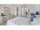 Guest bedroom with white bedding and built-in shelving at 660 Linden Dr, Englewood, FL 34223