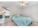 Light and airy bedroom with a ceiling fan and light blue bedding at 660 Linden Dr, Englewood, FL 34223
