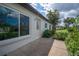 Home's exterior showcases a light-colored facade and a patio area at 660 Linden Dr, Englewood, FL 34223