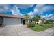 Single-story home with attached garage and landscaped yard at 660 Linden Dr, Englewood, FL 34223