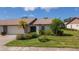 Single story home with attached garage, and nicely landscaped front yard at 660 Linden Dr, Englewood, FL 34223