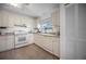 Updated kitchen boasts white cabinets, modern appliances, and tile flooring at 660 Linden Dr, Englewood, FL 34223