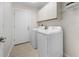 Laundry room with washer, dryer, and extra storage at 660 Linden Dr, Englewood, FL 34223