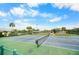 Community pickleball court with surrounding landscape and pond at 660 Linden Dr, Englewood, FL 34223