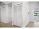 White louvered-door storage closet in the hallway at 660 Linden Dr, Englewood, FL 34223