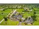 Aerial view of clubhouse with parking and surrounding green space at 67 Pine Valley Ct, Rotonda West, FL 33947