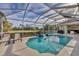 Inviting screened pool area with lounge chairs and views of the surrounding landscape at 67 Pine Valley Ct, Rotonda West, FL 33947