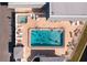 Aerial view of resort-style pool with hot tub and surrounding lounge chairs at 672 Circlewood Dr # V9, Venice, FL 34293