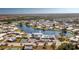 Aerial view of community featuring a lake and clubhouse at 672 Circlewood Dr # V9, Venice, FL 34293