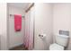 Updated bathroom with shower, toilet, and a pink patterned shower curtain at 672 Circlewood Dr # V9, Venice, FL 34293