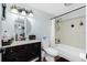Clean bathroom with dark vanity, toilet and bathtub at 672 Circlewood Dr # V9, Venice, FL 34293