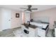 Bright bedroom with king-size bed and ceiling fan, offering a tranquil atmosphere at 672 Circlewood Dr # V9, Venice, FL 34293