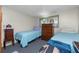 Small bedroom with twin beds and wood dresser at 672 Circlewood Dr # V9, Venice, FL 34293