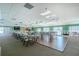 Large community room with tables, chairs, and dance floor at 672 Circlewood Dr # V9, Venice, FL 34293