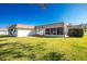 White house with brown roof, screened porch, and grassy backyard at 672 Circlewood Dr # V9, Venice, FL 34293