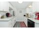 Modern kitchen with white cabinets and granite counters at 672 Circlewood Dr # V9, Venice, FL 34293