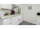 Updated kitchen with white cabinets, granite countertops, and modern appliances at 672 Circlewood Dr # V9, Venice, FL 34293