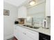 Clean and bright kitchen with white cabinets, double sink, and stainless steel appliances at 672 Circlewood Dr # V9, Venice, FL 34293